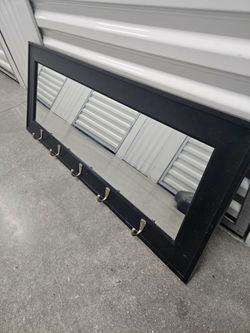 Wall mirror with hooks