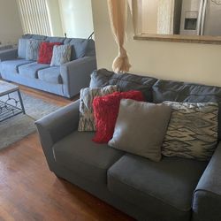 Ashley Furniture  Sofas  With Pillows Included.  Color Is Gray.