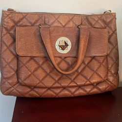 A quilted brown leather Kate Spade satchel with gold-tone hardware.