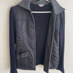 This piece of clothing is a knit panel jacket or a knit patchwork coat.  • The sleeves and back are made of knitted fabric (like a sweater), which is 