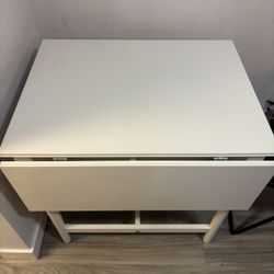 White wooden dining table with adjustable side leaves