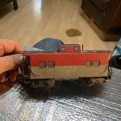 This is a vintage Marx NYC 20102 O-scale model train caboose. 
