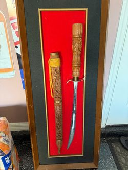 Displayed antique Asian sword.