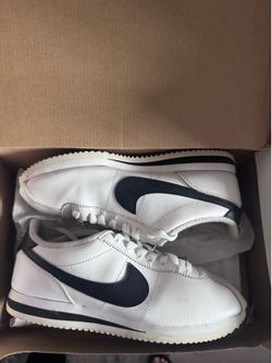 Nike Cortez Basic Leather sneakers in white and black.