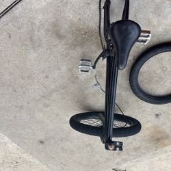 Bike frame with brakes at tire and a clamp and the stem and the chain all functional just needs a back tire in handlebars by handlebars are inclcluded