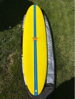 Yellow woody resin surfboard 6’10”