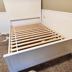 Full size kids bed frame with header.
