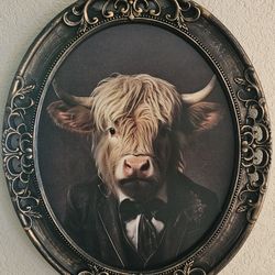Elegant Cow Wall Decor. New

Dimensions: 24.25" H x 20.25" W x 1.5" D
Material: Plastic & MDF
Shape: Oval
Color: Black, Gold, Tan & Pink
Orientation
