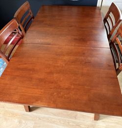 Ashley hidden leaf dining table with four chairs