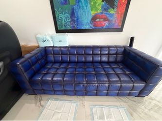 blue leather tufted / channel-tufted sofa with square arms.