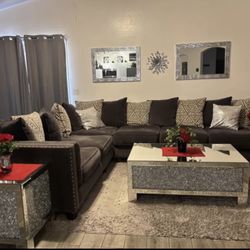 Large Charcoal Grey Sectional Sofa with Nailhead and mirrored bling coffee and end table.