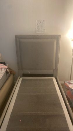 Grey upholstered twin bed frame