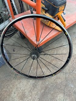 Aluminum Mavic Ksyrium Elite rear road bike wheel has a black finish with red and white graphics. This wheel includes a 10-speed cassette and a quick-