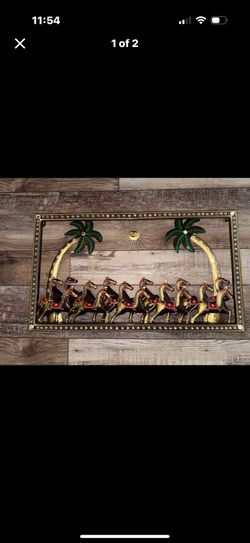 Metal horse wall art with palm trees and sun