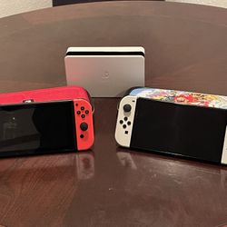 Two Nintendo switches, Charging Station With Cases And 5 Games $350