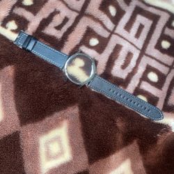  Shinola The Mechanic 39mm watch with a dark olive leather strap. 