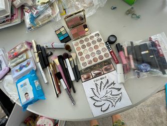 Lots of make up (lots of it unused), makeup brush brushes (some MAC), make up remover, eyelashes, dress tape, lipstick, eyeliner