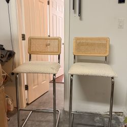 Modern bar stools with a clean, minimalist aesthetic.