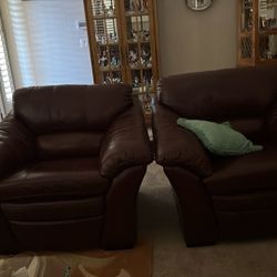 Two Leather Chairs With Ottomans 