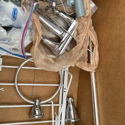 Silver Bathroom Faucet With Screws And Other Bathroom Accessories