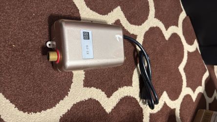 This device appears to be an electric instant tankless water heater designed for under-sink use in kitchens or https://offerup.com/redirect/?o=YmF0aHJ
