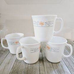 Set of 4 Corning 3.5"×3" White Handled Coffee Mugs Teacups with Dainty Blue and Peach Floral Motif Design.

Pre-owned in excellent clean condition.  N