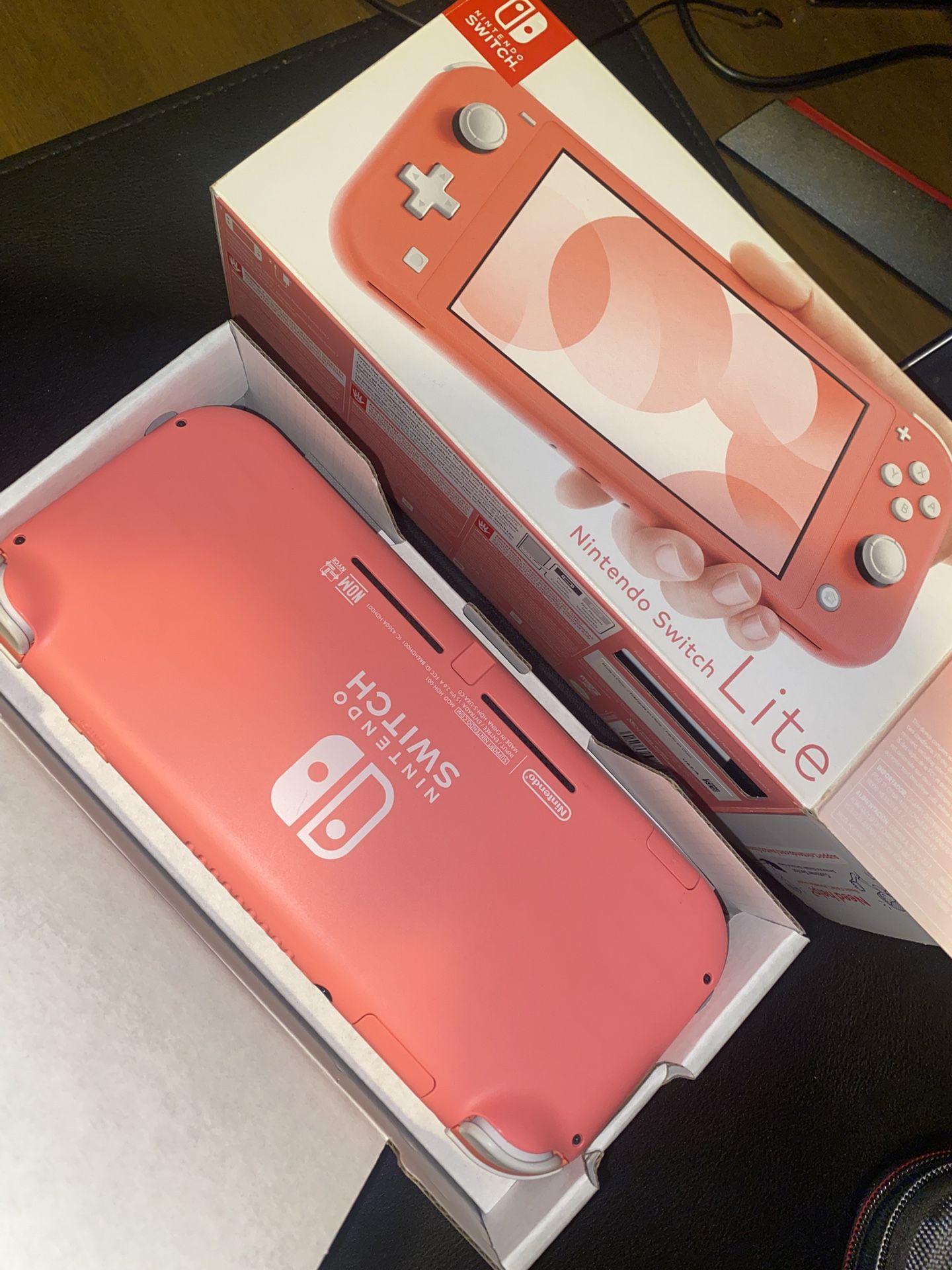 Pink Nintendo Switch Lite with travel case