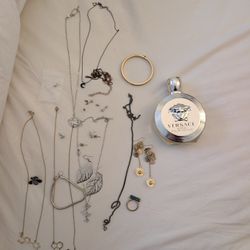 A Bunch Of Jewelry And Bottle Of Flagrance