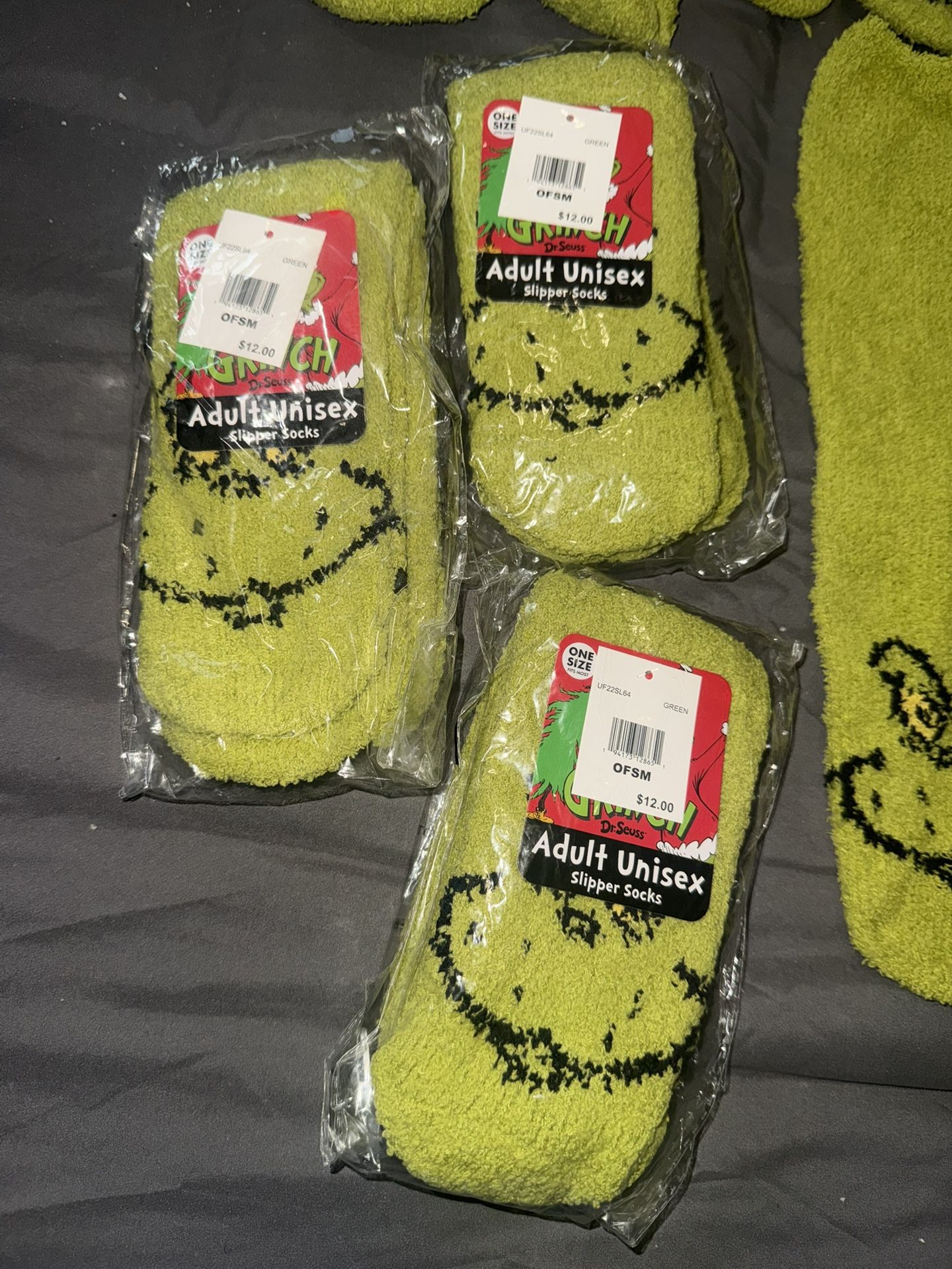 10 pair grinch socks . 3 new and 7 used for Xmas pictures only Regular price per pair 12.99 selling 10$ each pair