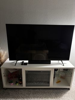 Samsung 65-inch 4K TV and White fireplace TV stand