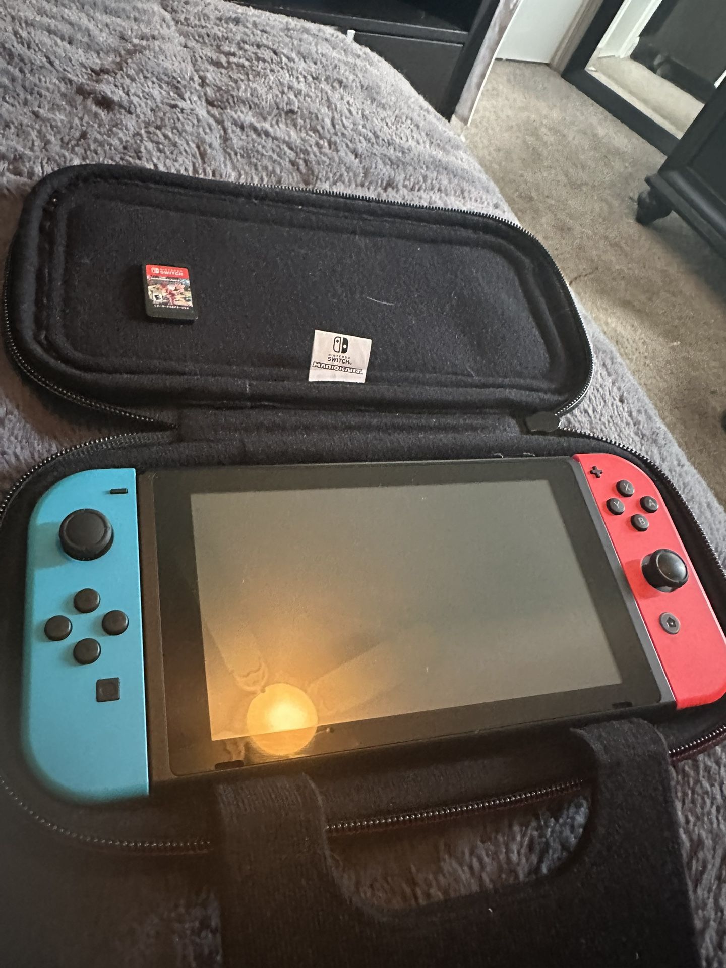 Nintendo Switch charger and a Mario Kart game