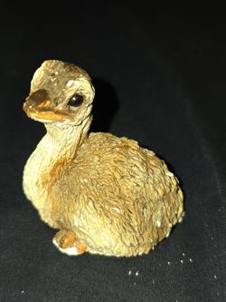 small figurine of a sitting  baby ostrich