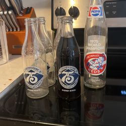 75 Coca Cola Anniversary Bottles 1 Of The Bottles Is full And  1975 World Champion Cincinnati Reds Pepsi Bottle 