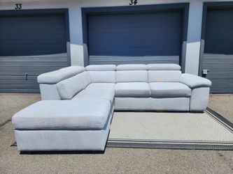 Living Spaces Sleeper Sectional Couch with Storage Ottoman