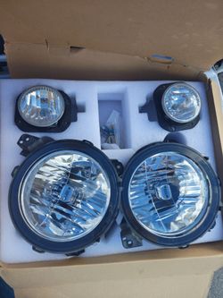OEM headlights + fog lights from a 2022 Jeep Gladiator.