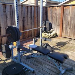 older used weight rack, bench and weights.