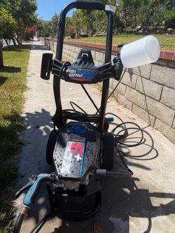 Powerful electric pressure washer is black with blue accents. This AR Blue Clean XP+3 model has a 2400 PSI rating and a 1.16 GPM flow rate. It include