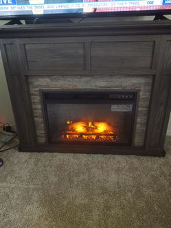 Electric fireplace with flame and temperature.