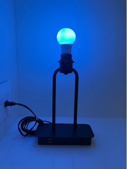 Black new modern lamp with blue bulb.