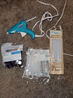 Glue gun, heart shape confetti, purple gems, and blue and pink petals