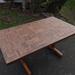 vintage wood trestle dining table with a parquetry top. oak and maple wood