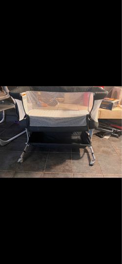 Bedside bassinet with diaper genie and wipe warmer