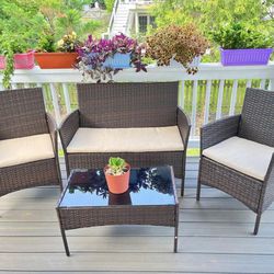 Patio Furniture Set New in Original Packaging 4 Piece All Weather Rattan With Cushions.