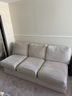 Cream colored couch with pull out mattress