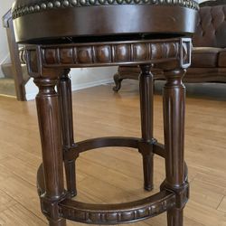 Backless kitchen stool with swivel mechanism and faux leather seat. Height 26 inches.