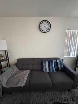 Dark gray sofa set of 2 with decorative pillows and throws