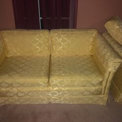 Two Yellow Couches With Arm Handle Covers