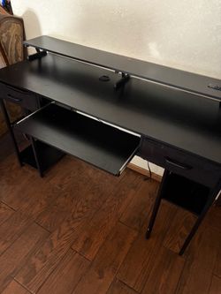 Black desk with outlets and drawers