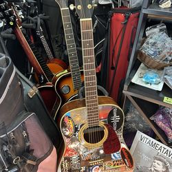 Fender Acoustic Electric Custom Guitar covered in band stickers