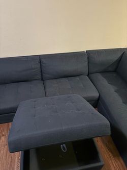 Navy blue sectional couch and storage ottoman